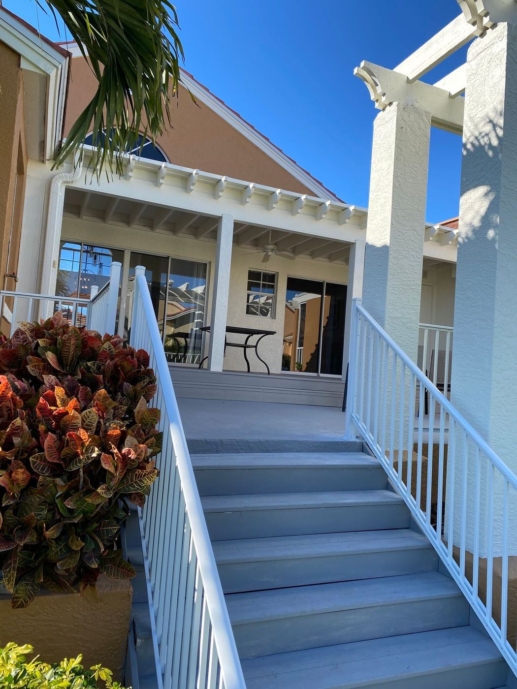 Porch stairs: New stairs and white railing