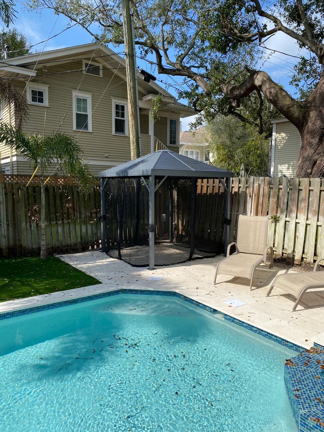 Pool gazebo: Screened gazebo assembled by the pool