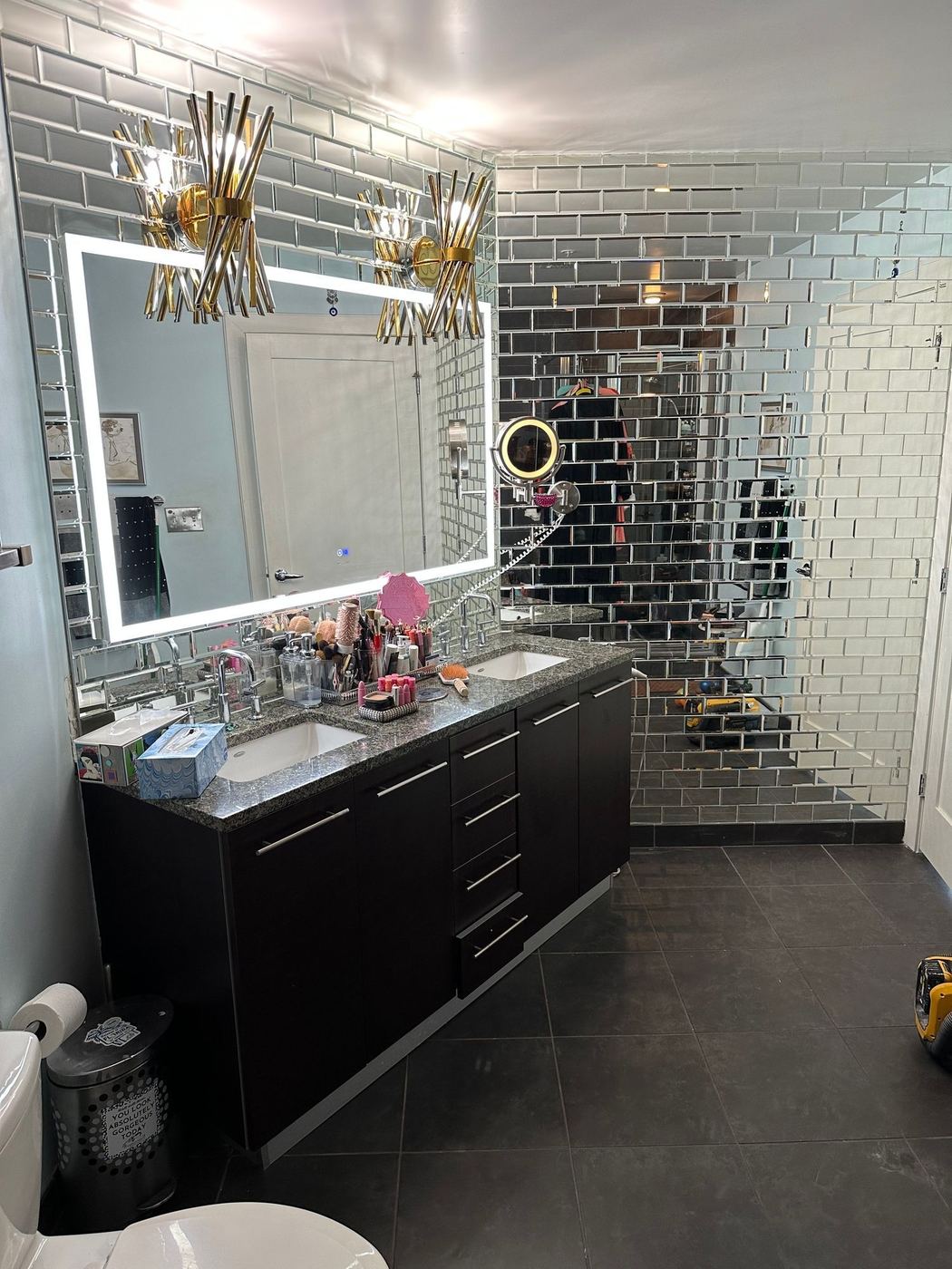 Mirrored tile wall with lighted vanity mirror