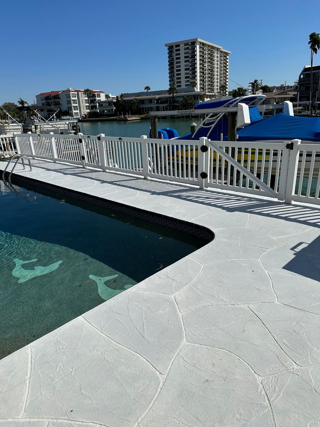 Waterfront pool with white fence