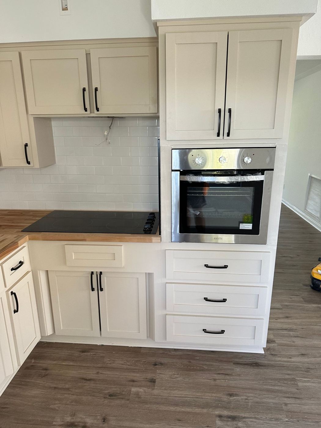 Kitchen: White shaker cabinets with wall oven