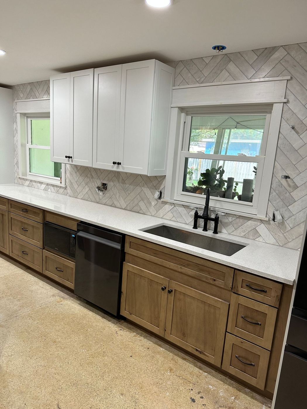 Kitchen remodel: Wood cabinets, quartz and herringbone tile