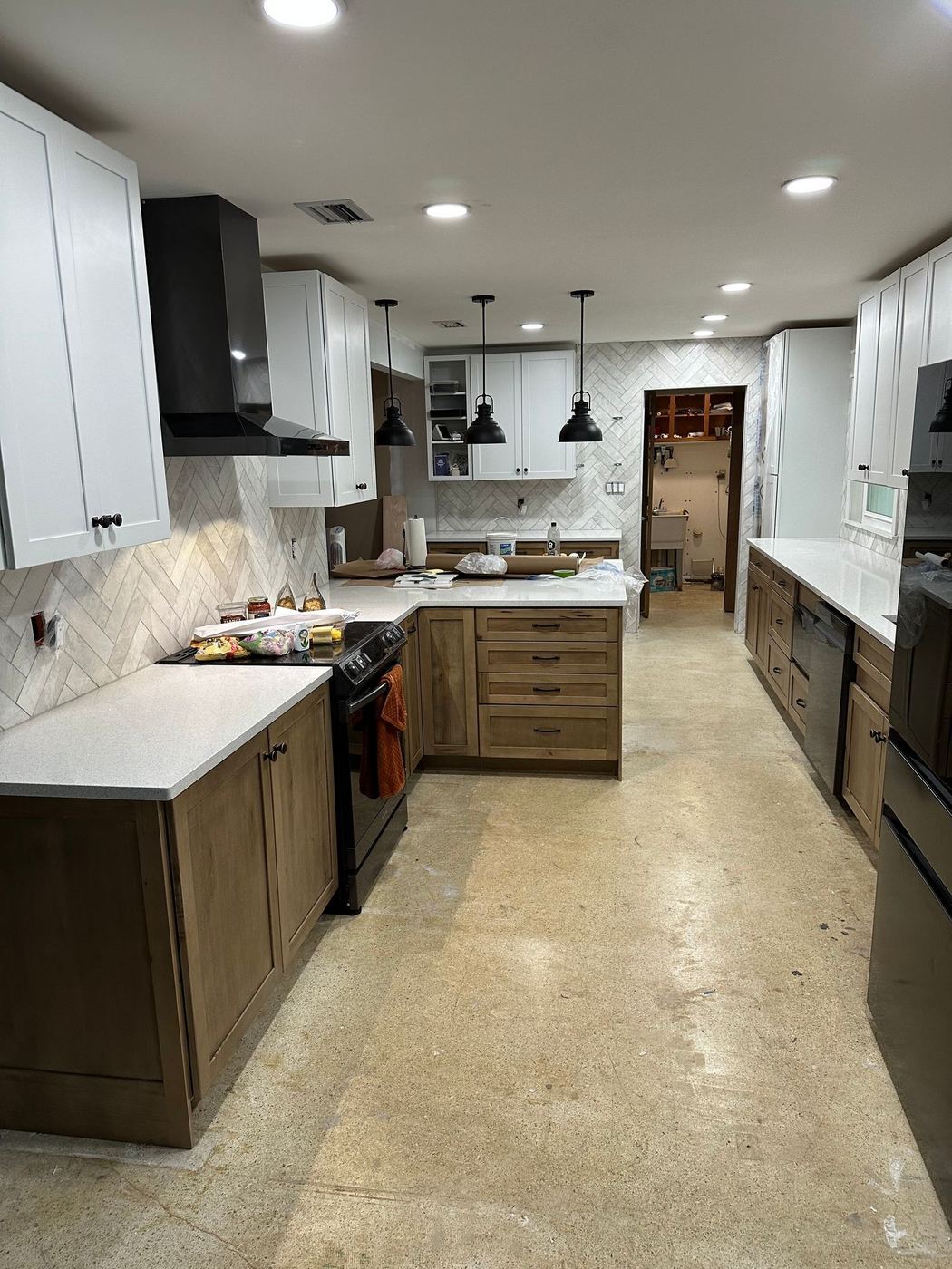 Galley kitchen remodel with black range hood